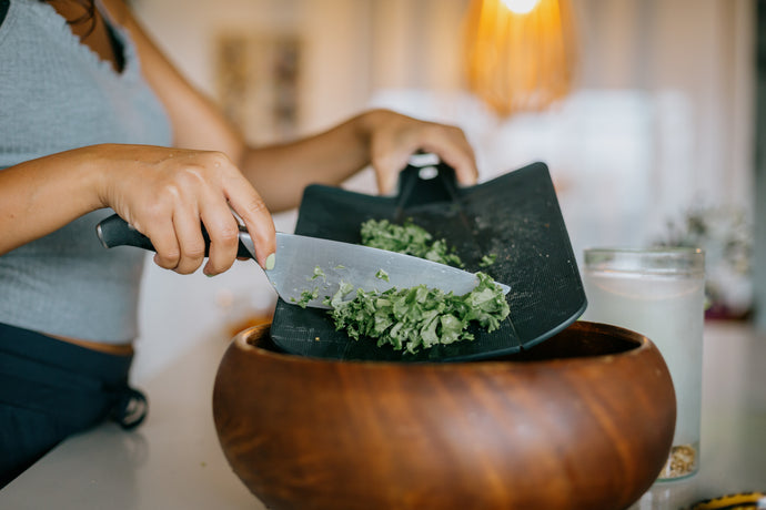 https://indulgekitchensupplies.com/cdn/shop/files/knife-scraped-kale-into-wooden-bowl_345x_crop_top@2x.jpg?v=1698850486